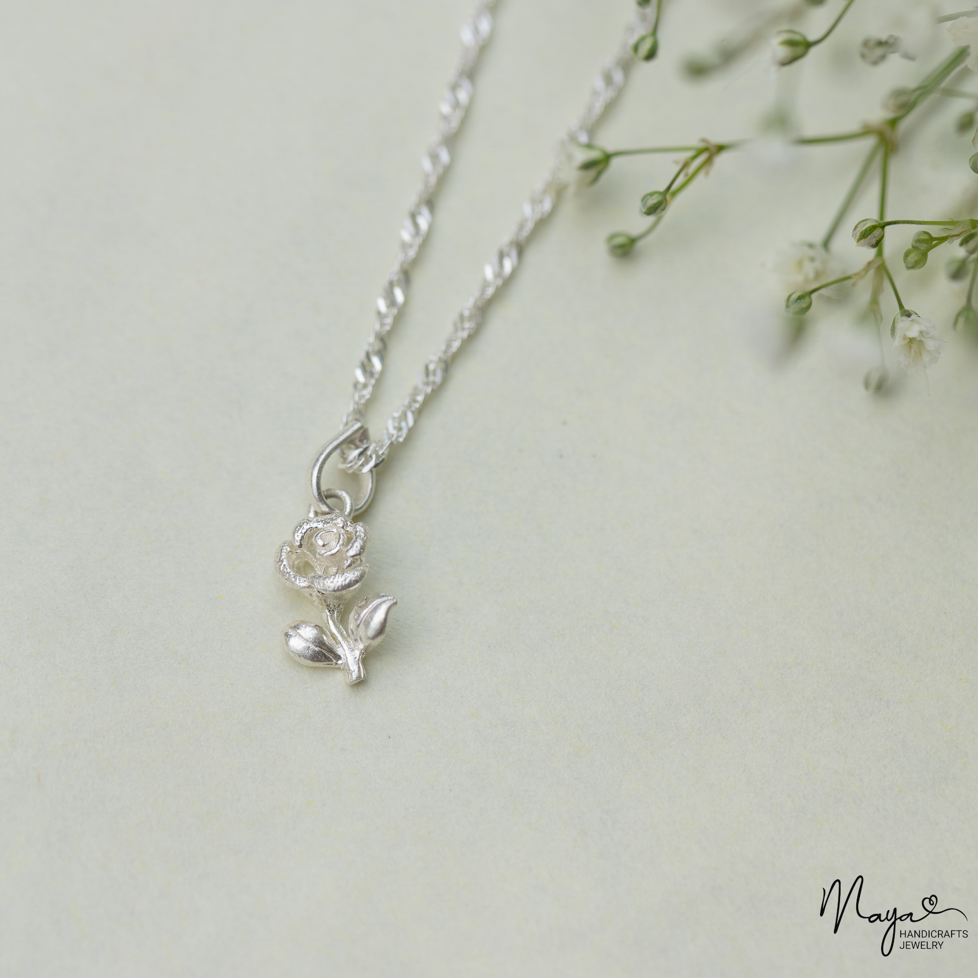 Rose with leaf pendant